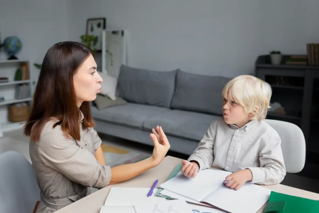 Father signing paperwork beside son during child support meeting
