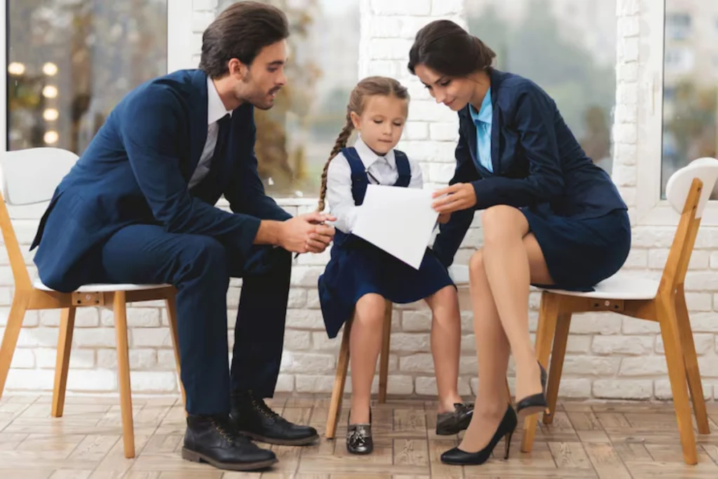 Child support attorneys reviewing document with parents and young girl